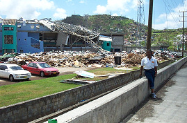 Eleanor Swan in front of badly-damaged National Stadium